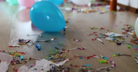 Floor with after party celebration with empty bottles, wine glass and party deco Stock Footage 148732092