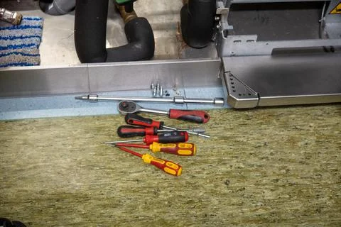 On a floor are some different tools and screws Stock Photos