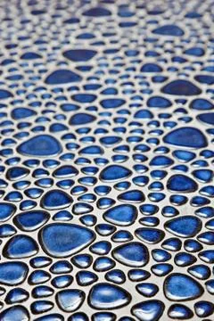 Floor with blue pebble mosaic pattern Stock Photos
