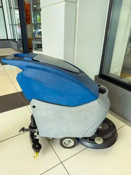 Floor cleaning machine inside a shopping center during daytime work hours Stock Photos