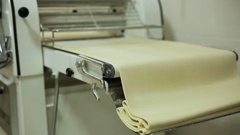 Floor Dough sheeter and large piece of dough, bakery process  Video stock 106473078
