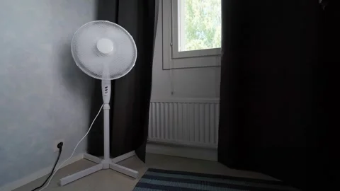 Floor fan in corner of room by window Stock Footage 345733460