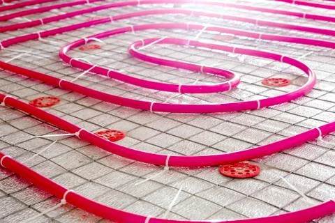 Floor heating pipe. Installation of engineering systems in a building. Fotos de archivo