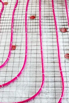 Floor heating pipe. Installation of engineering systems in a building. Fotos de archivo