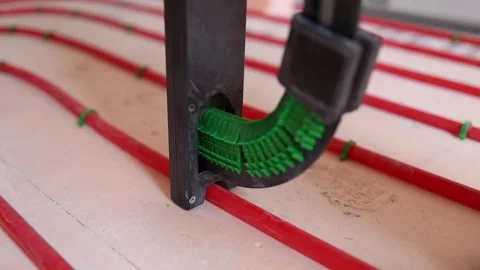 Floor heating stapler tool fixing plastic pipes for underfloor heating Stock Footage 315507637