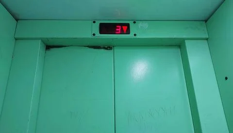 Floor indicator inside the elevator. A battered elevator cabin. Stock Photos