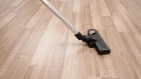 The floor with laminate is cleaned with a vacuum cleaner. Stock Footage 149755114