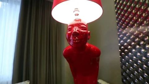 The floor lamp in the form of the red man Stock Footage 73776377