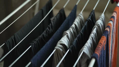 A floor laundry rack with wet clothes and colorful towels. Stock Footage 341241727