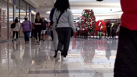 Floor-level view of diverse Christmas shoppers at upscale indoor mall Видео 165255890