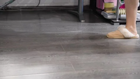 Floor mopping in indoor space with reflective hardwood surface Stock Footage 323178946