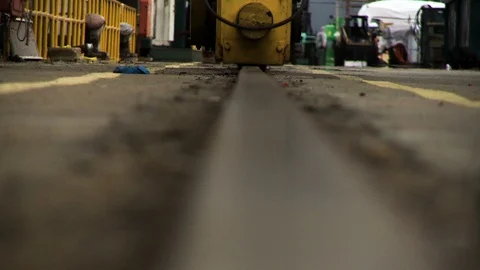 Floor or ground pov of busy harbor construction site near cruiseship Stock Footage 123728408