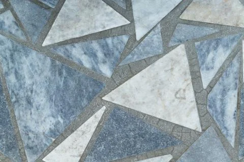 Floor or surface lined with marble slabs of triangular form. Stock Photos