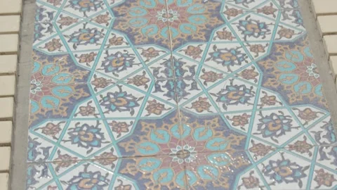A floor paved with ceramic tiles with patterns. Close-up of a mosaic floor. Stock Footage 262352717