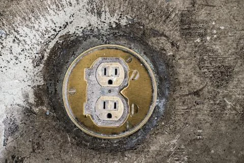 Floor Plug sockets built in to concrete ground, worn concrete floor Stock Photos