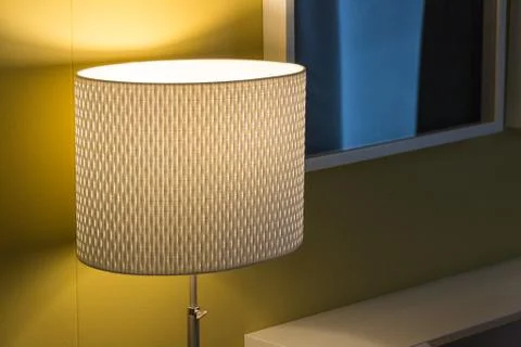 Floor retro lamp on two boxes in the room with a wooden floor and grunge text Stock Photos