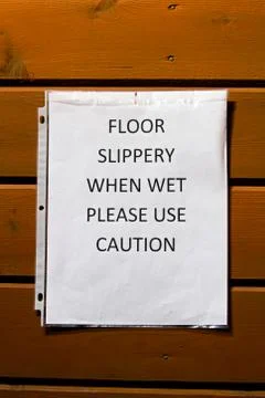 Floor slippery when wet use caution sign Stock Photos