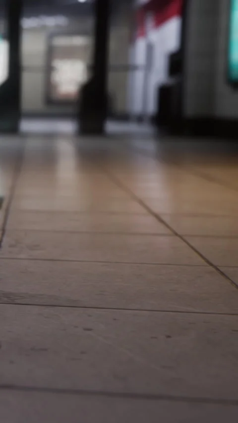 Floor tiles in a busy area with shadows of people walking by in the background Stock Footage 337945872