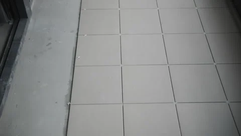 Floor tiles with spacers in installation process Stock Footage 300336556