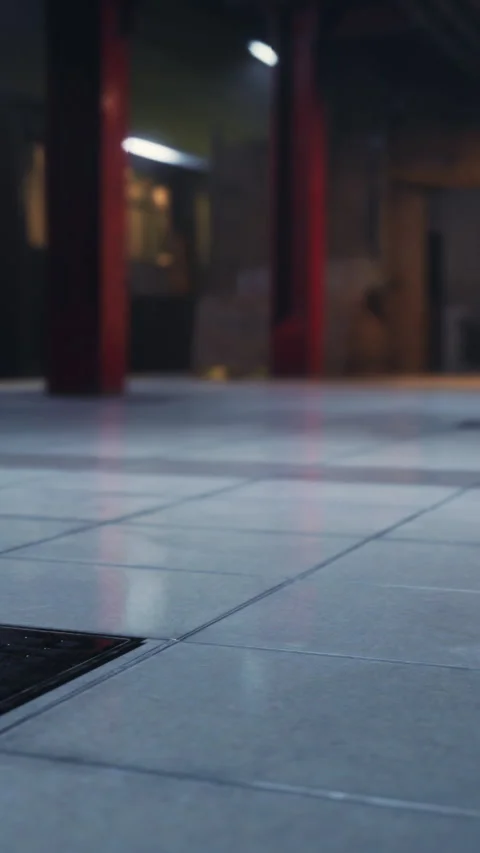 Floor tiles in urban space with light source creating shadows in the background Stock Footage 338384808