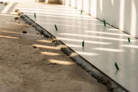 Floor tiling installation process home renovation construction indoor close.. Stock Photos