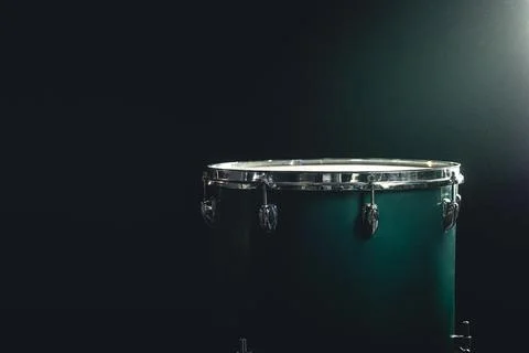 The floor tom on under studio lighting, copy space, music concept. Stock Photos
