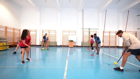 Floorball players training and practicing in a gym Stock Footage 316693363