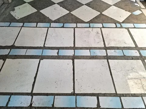 Flooring texture featuring white square tiles arranged with blue rectangula.. Stock Photos
