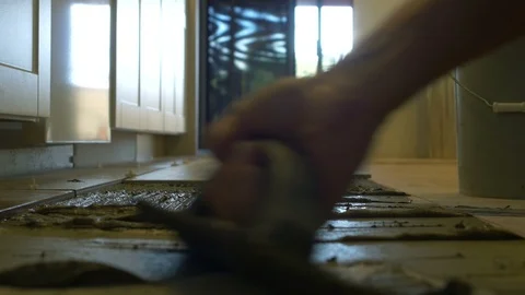 Flooring worker spreading mortar with a trowel Stock Footage 108539736