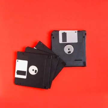 Floppy disk magnetic computer data storage support on a red back 스톡 사진