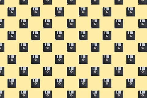 Floppy diskette pattern on yellow background Stock Photos