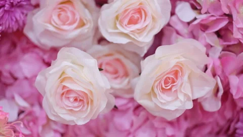 Floral background texture. Artificial flowers in pastel colors on the wall. Stock Footage 233199332