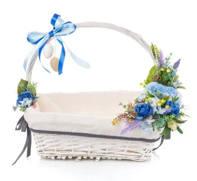 Floral easter decor in blue on a white wicker basket on white background Stock Photos