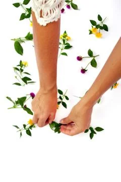 Floral pattern with hand, pink clover and yellow wildflowers on white background Foto stock