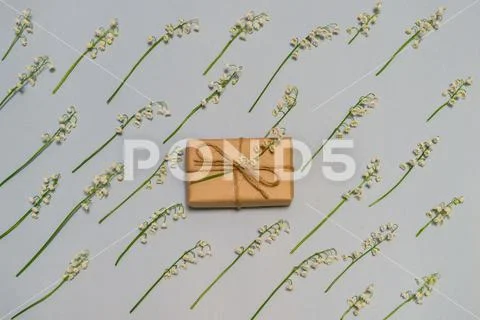 Floral pattern of lily of the valley flowers on light pastel background with Stock Photos