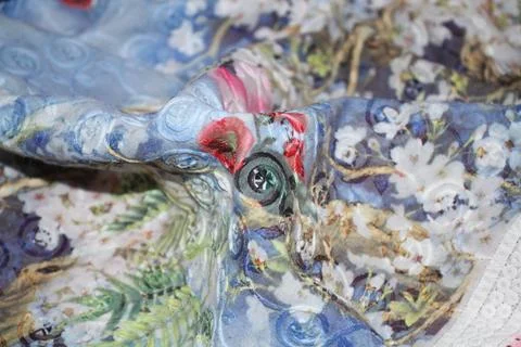 Floral patterned fabric with a hidden button. Fotos de archivo