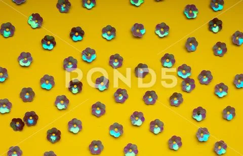 Floral purple confetti on yellow background, top view, seamless pattern. Stock Photos