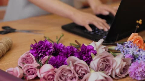 Floral store. Close up. Hands woman florist. Female florist in apron at Stock Footage 166364101