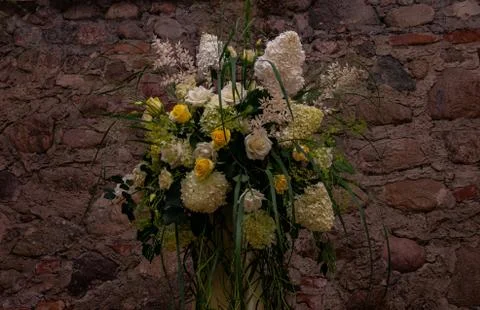 Floral work on a stand with white hydrangea on a stone wall Stock Photos