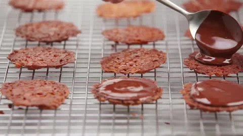 Florentines being spread with chocolate glaze Stock Footage 24653321