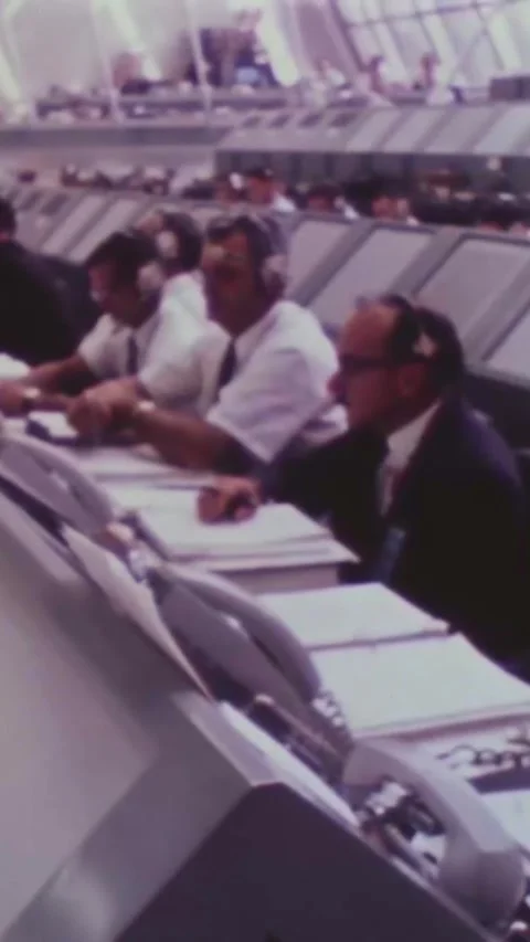 FLORIDA - 1969 - Men work at consoles in the Kennedy Space Center's Launch Stock Footage 342654386