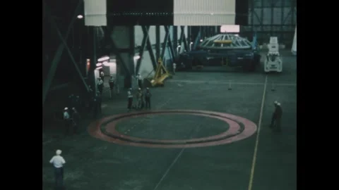 FLORIDA - 1969 - Technicians look on as Apollo 13's S-II stage is lowered inside Stock Footage 340652492