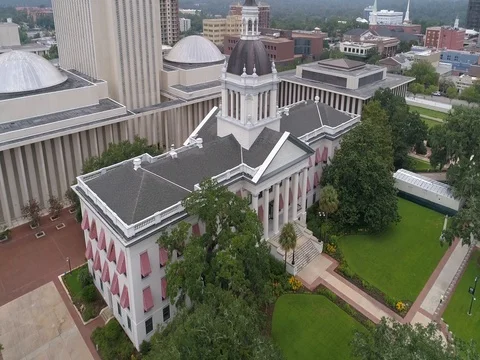 Florida Capitol Complex fast aerial circles around Old Florida Capitol Stock Footage 79357843