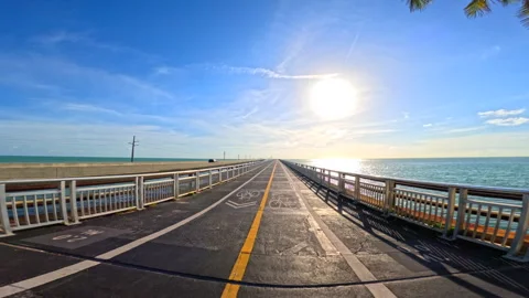 Florida Keys Overseas Heritage Trail bridge riding into the sunset Stock Footage 335663139