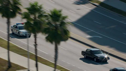 Florida police chase black car weaves through traffic Stock Footage
