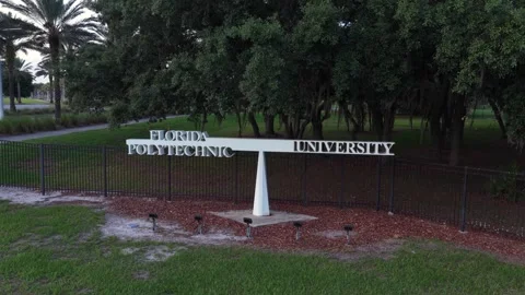 Florida Polytechnic University’s angled white monument sign stands behind black Stock Footage 340042488