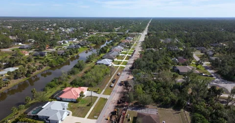 Florida residential road under construction with excavators, cones, and warning Stock Footage 325404357