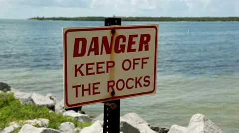 Florida tropical coast beach danger sign rocks 1 Stock Footage 34013501