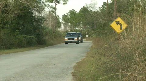 Florida, USA - Year 2007: SUVs in a curve of scenic Loop Road - Editorial Stock Footage 106783