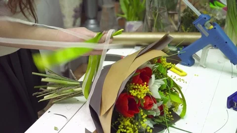 Florist adding ribbons to the bouquet Stock Footage 73946827